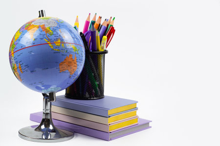 Globe, books and pencils close-up on white background with space for text. High quality photoの写真素材