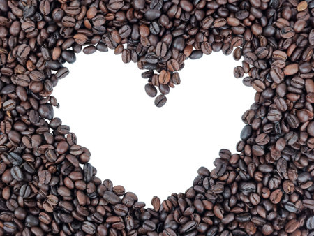 A beautifully crafted arrangement of coffee beans creatively forming a heart shape for coffee lovers everywhereの写真素材
