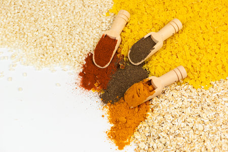 Explore vibrant spices and grains, showcased beautifully in unique wooden scoopsの写真素材