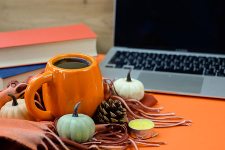 Hot cup of coffee on desktop near laptop and books, online learning and freelancing. High quality photoの写真素材