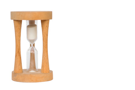This elegant wooden hourglass timer features flowing sand, making it perfect for time management or beautiful decorの写真素材