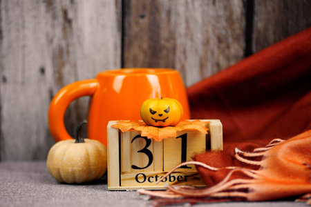 Coffee cup with autumn decor and wooden calendar. High quality photo