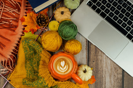 A Cozy Autumn Workspace Featuring a Laptop Surrounded by Charming Pumpkin Decor Itemsの写真素材