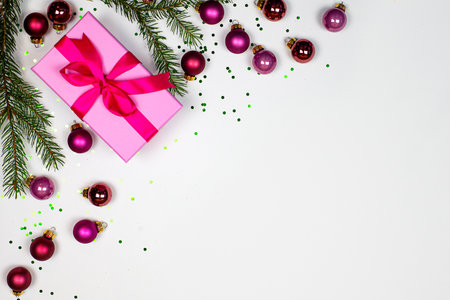 Christmas background.A Colorful Holiday Gift adorned with Beautiful Ornaments and Pine Branches for Festivityの写真素材