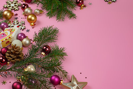 Christmas composition made with green Christmas tree and pink baubles on pastel pink background. Minimal Christmas and New Year concept. Creative festive holiday layout.の写真素材