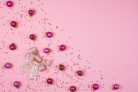 Christmas ball toys and confetti on color background, top view.の写真素材