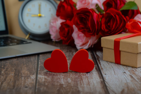 Two hearts with flowers and gifts on a wooden background. High quality photoの写真素材