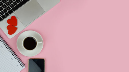 laptop and coffee with heart accents, pink desktop with notebook, smartphone and scattered small hearts,の写真素材