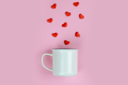 Cup with red hearts on a pink background, Valentine's Day theme. High quality photoの写真素材