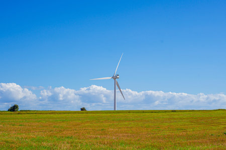 Wind Turbine On Open Prairie Under High White Clouds And Expansive Blue Sky, Minimal Composition...