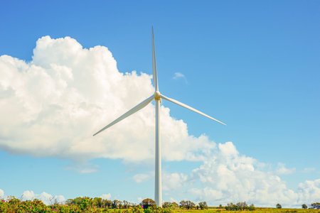 Towering Turbine Framed By Dramatic Clouds, Close Foreground Blade And Hub Detail, Crisp Sky Contrast And Industrial Elegance, Sustainable Energyの写真素材