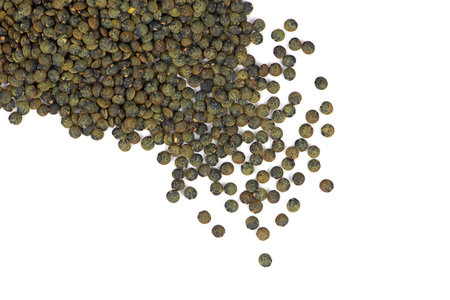 Black lentils isolated. Dry scattered beluga lentil grains, heap of raw dal, daal, dhal, masoor, Lens culinaris or Lens esculenta pulse pile on white background top viewの写真素材