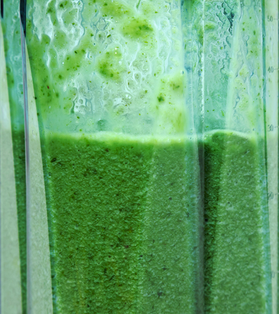 Green smoothie. Smoothie in blender closeup.の写真素材