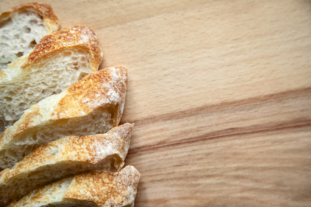 Freshly baked sliced bread on a wooden table. Closeup.の写真素材