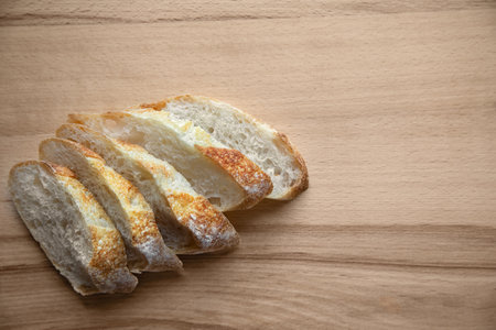 Freshly baked sliced bread on a wooden table.