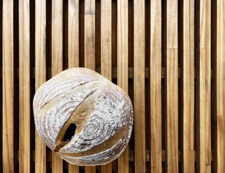 Freshly baked bread on a wooden table.の写真素材