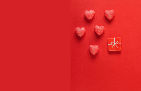 Sparkle hearts and toy present on red background. Valentine's day background.の写真素材