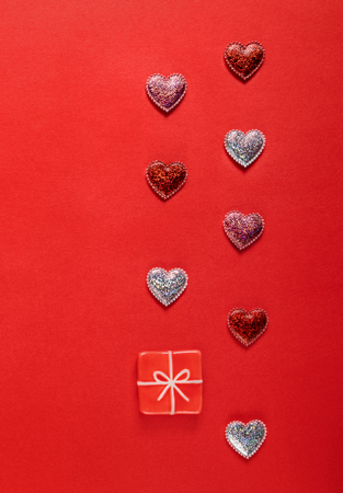 Sparkle hearts and toy present on red background. Valentine's day background.の写真素材