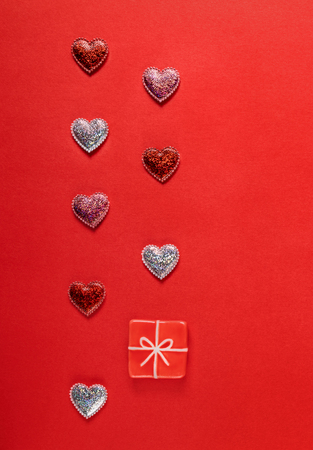 Sparkle hearts and toy present on red background. Valentine's day background.の写真素材