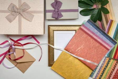 All things for gift wrapping with frame on white background. Present box with bow. Ribbon and color paper.の写真素材