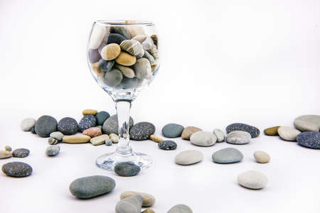 Glass with ocean rocks on white backgroundの写真素材