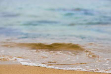 Beautiful sea summer abstract background -sand beach with blue ocean wavesの写真素材