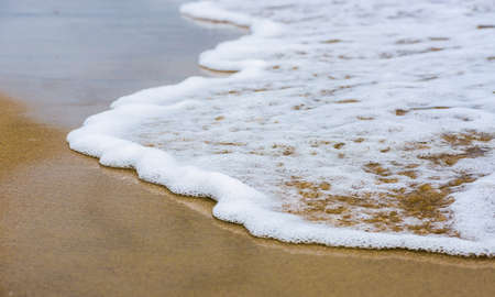 Beautiful sea summer abstract background -sand beach with blue ocean wavesの写真素材