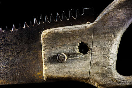 Old handsaw on the black background - closeupの写真素材