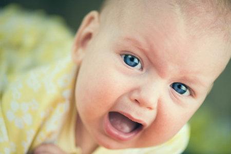 Portrait of crying baby girl.の写真素材