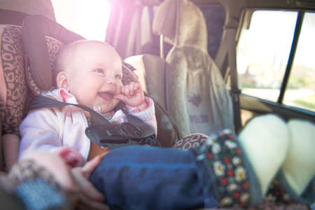 Cute toddler boy sitting in car seatの写真素材
