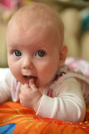 A cute dreamly little baby girl portrait at homeの写真素材