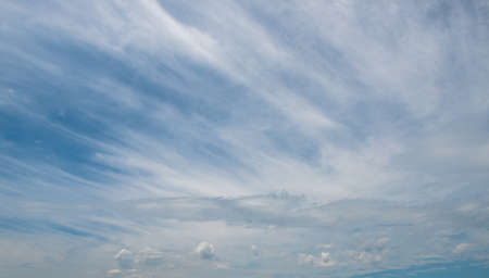 Blue sky background with cloudsの写真素材