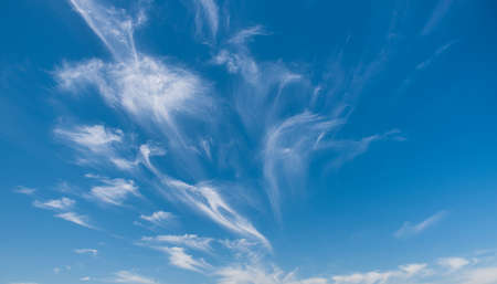 Blue sky background with cloudsの写真素材