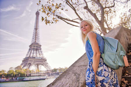 Blond girl looking at the Eiffel tower in Parisの写真素材