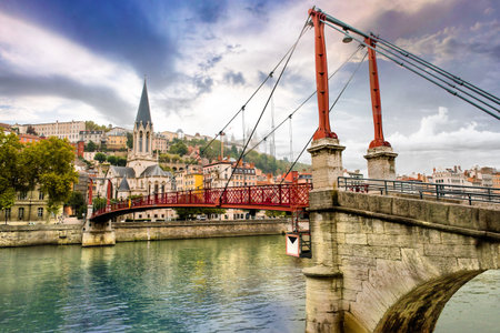 Pedestrian Saint Georges footbridge and the Saint Georges church in Lyon, France