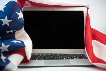 US flag and laptop on white background with copy spaceの写真素材