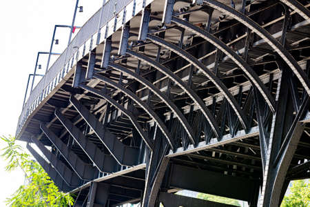 Urban gray metal bridge on sunny day. Steel bridge strong and big.の写真素材