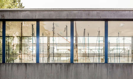 Reflection in windows of bridge masts yachts. Four windows which shows ships.の写真素材