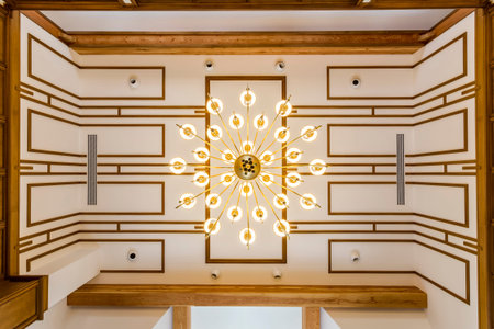 Ceiling in the living room in country house with beautiful chandelier. Design and modern gold...