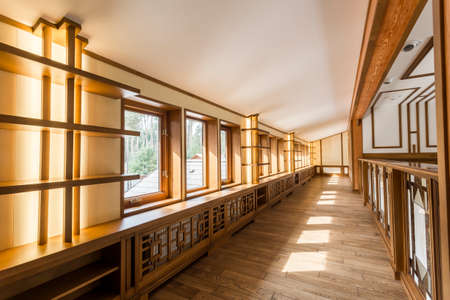 Interior corridor with hardwood walls and windows in empty house. Home design modern new and beautiful. Wood on the walls light brown.の写真素材