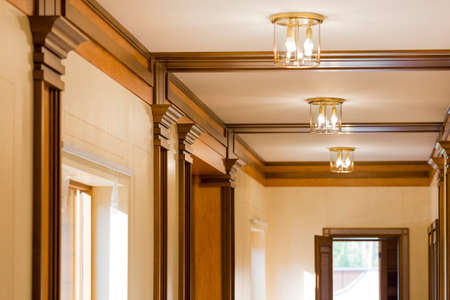 Interior corridor in ecological house.Illuminated light bulb on the ceiling.The wide windows with views of green garden. Design facilities new and modern.の写真素材