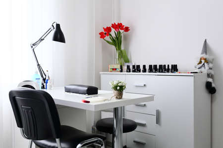 Working space for manicure with chear, nail manicure, bright room and equipmentの写真素材