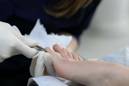 Removing cuticle with cuting cuticle forceps. Close up viewの写真素材