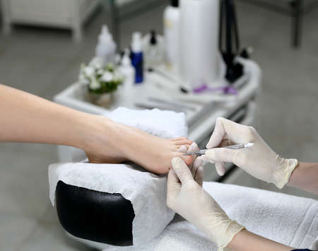 Cuticle removing in a beauty salon, on the background of the equipmentの写真素材