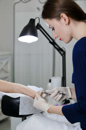 Workibg master in pedicur salon with clientの写真素材