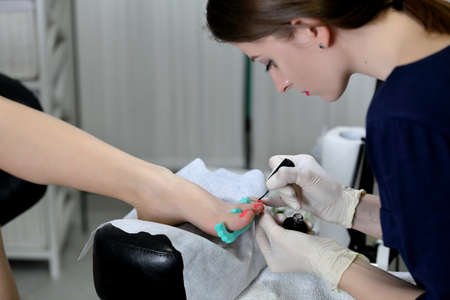 Professional pedicure master making pedicure in salonの写真素材