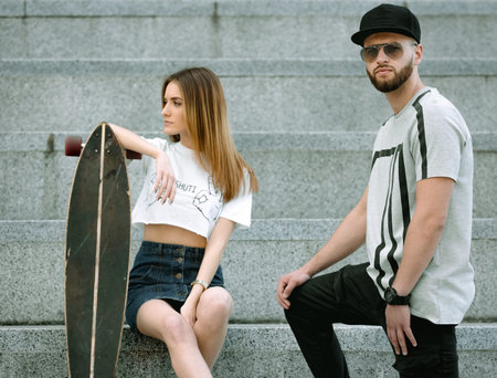Portrait of stylish and fashionable couple, shoot in a urban location. Young bearded man and woman...