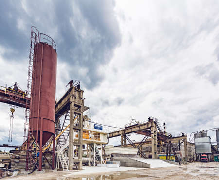 KIEV, UKRAINE - MAY 20, 2016: Old factory for concrete production. The staff and machines of the old workshop of concrete production. Technological processes of concrete productionのeditorial素材