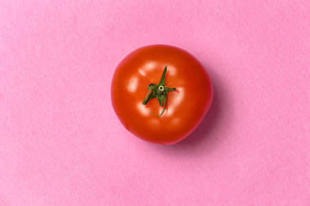 Top view of red tomato on a pink backgroundの写真素材