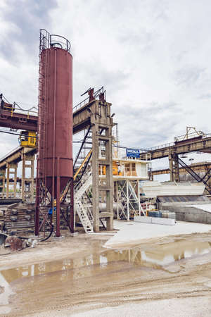 KIEV, UKRAINE - MAY 20, 2016: Old factory for concrete production. The staff and machines of the old workshop of concrete production. Technological processes of concrete productionのeditorial素材